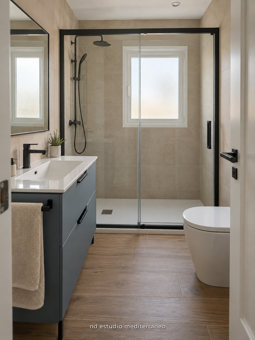 Baño con ducha acristalada, grifería negra y mueble azul grisáceo